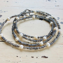 Charger l&#39;image dans la galerie, Labradorite pearl necklace 40 inches featuring grey iridescent gemstones and white freshwater pearls on rustic wooden background.
