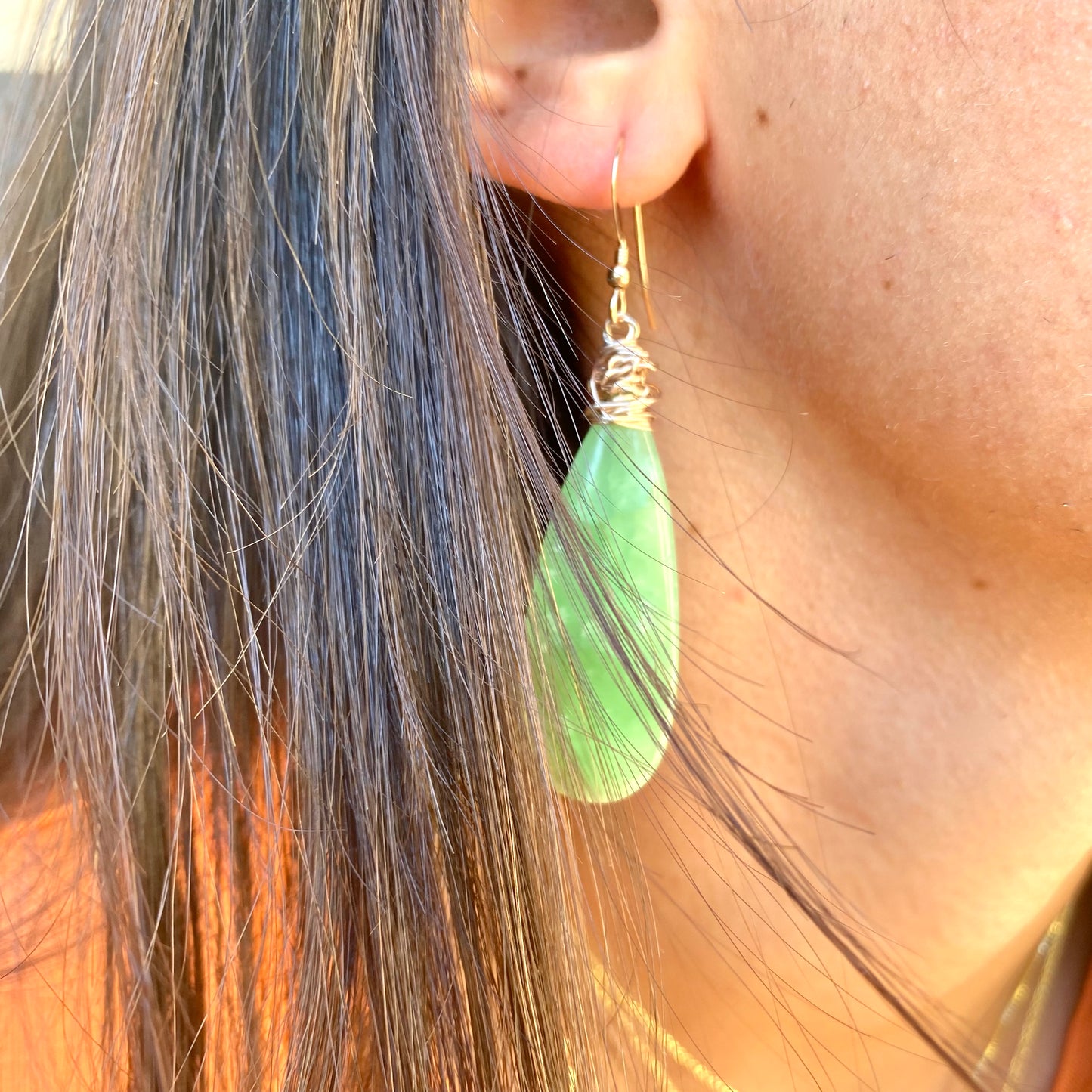 Teardrop green onyx earrings worn on model showing elegant elongated drop length