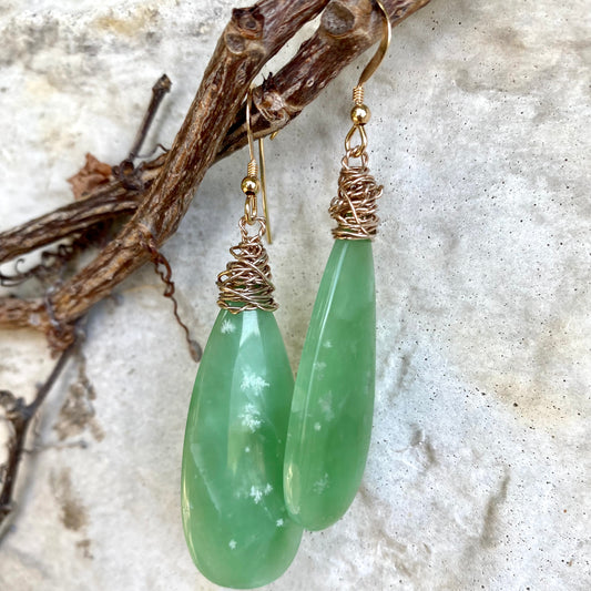 Teardrop green onyx earrings displayed flat highlighting smooth teardrop gemstone shape