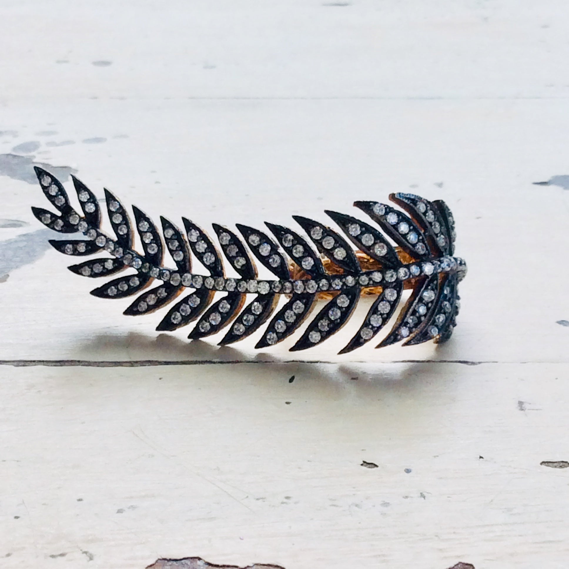 Vermeil leaf shape ring showcasing an antique finish and cubic zirconia embellishment, artistic gold statement jewelry.