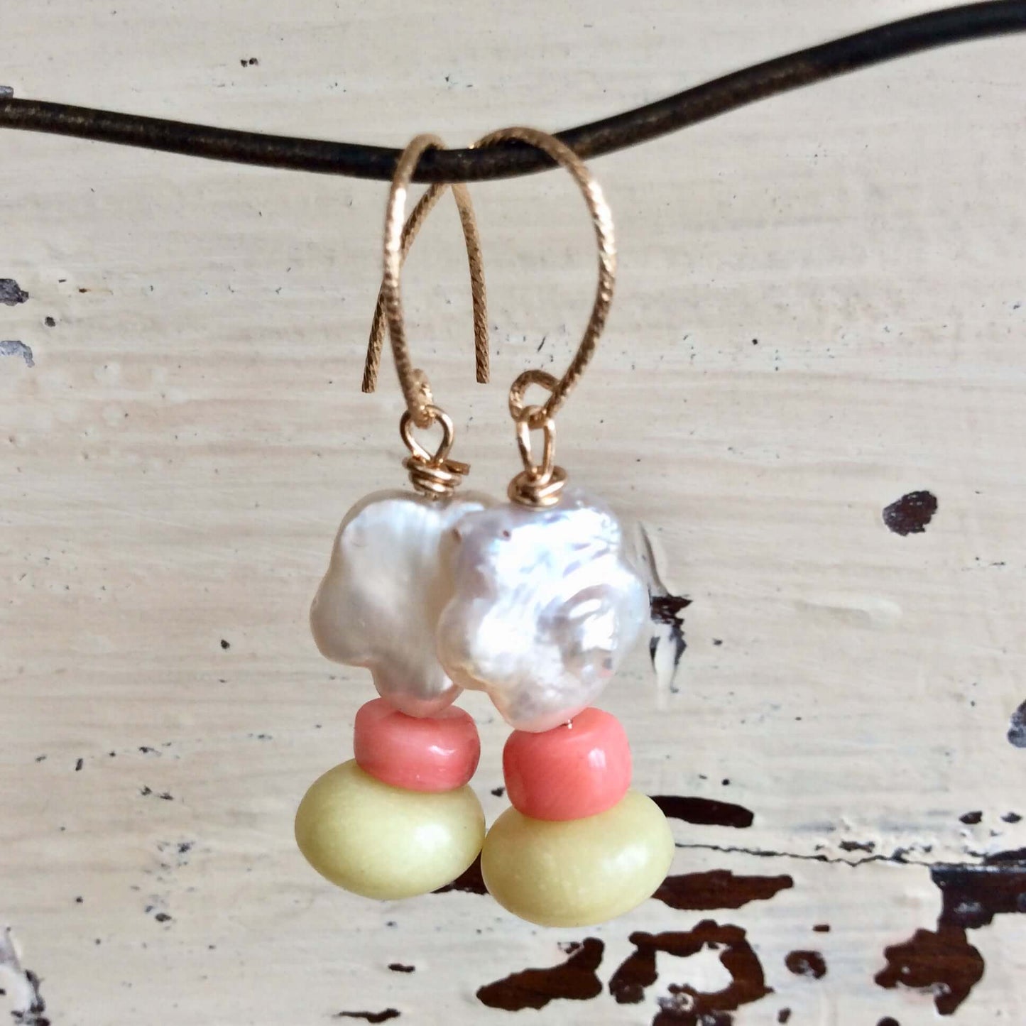 Dainty pearl drop earrings with baroque pearls, pink coral, and green quartz accents in floral design.