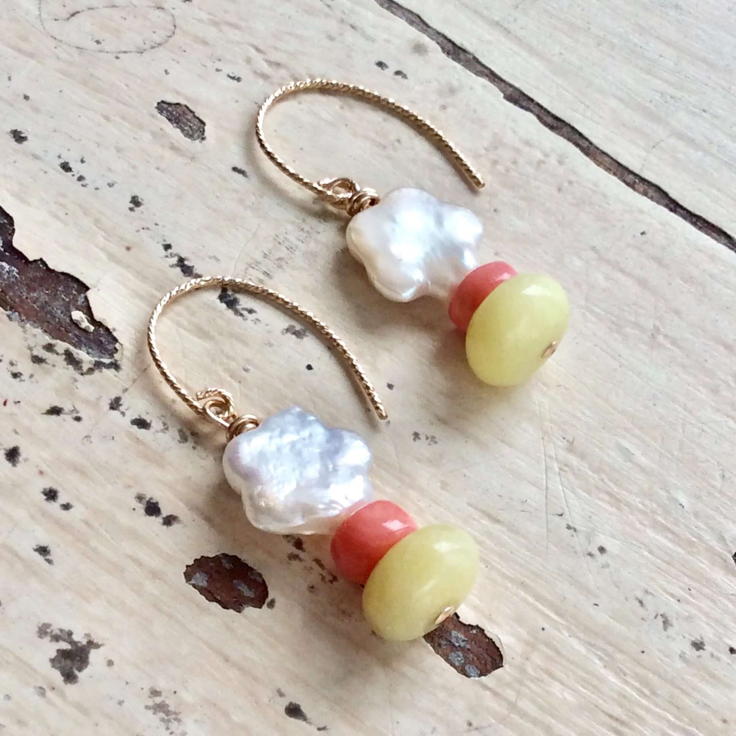 Dainty pearl drop earrings featuring baroque freshwater pearls, pink coral accents, and green quartz gemstones.