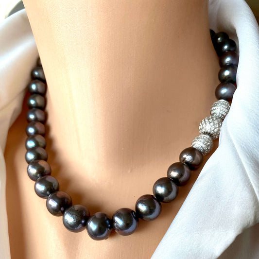Side view of black pearl silver necklace worn by mannequin in white blouse, 18-inch handmade jewelry piece
