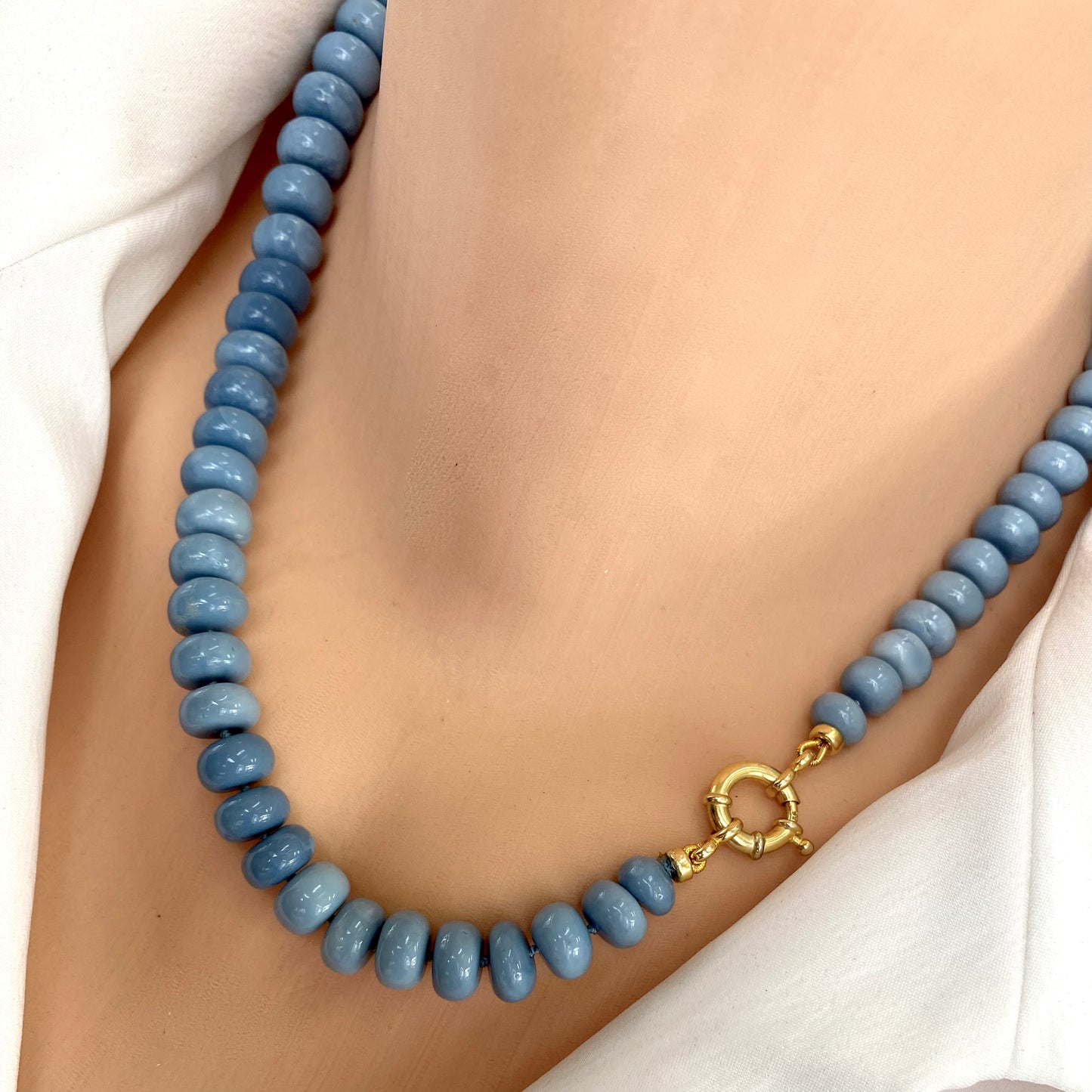 Blue opal necklace worn on model, graduated blue opal rondelles with gold vermeil clasp
