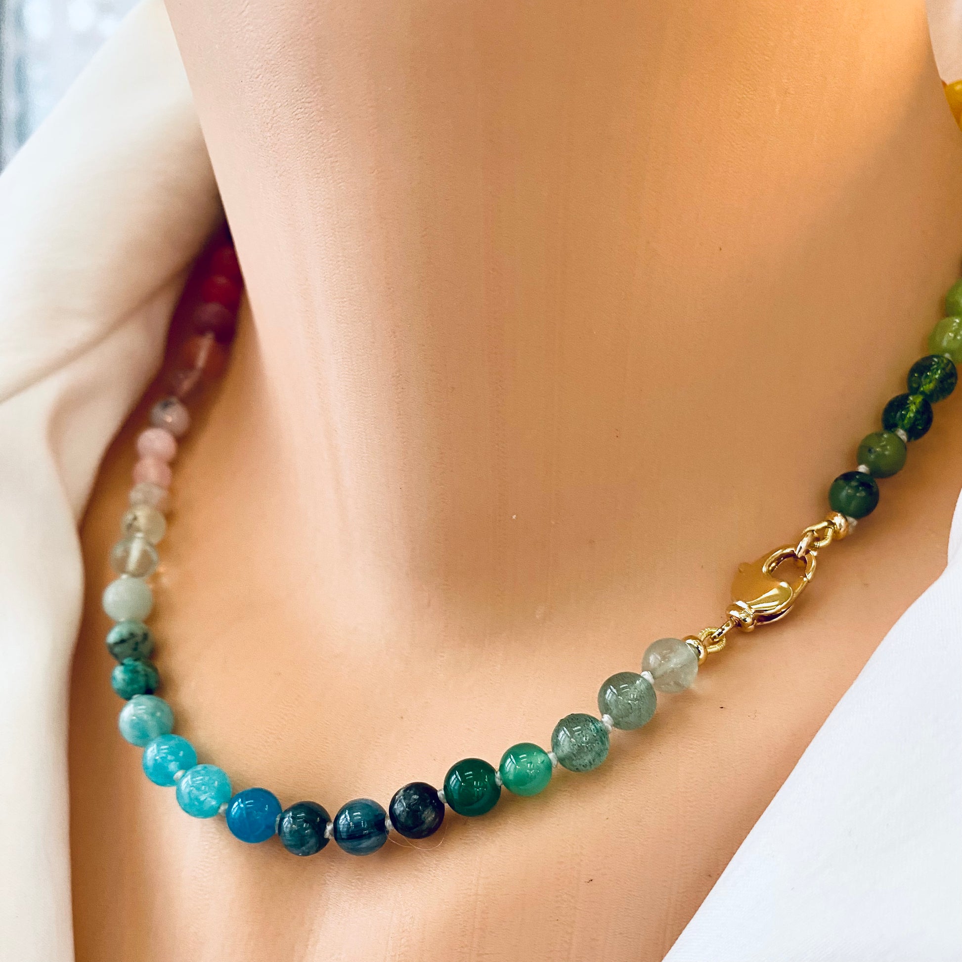 Rainbow candy necklace in mini gemstone beads showcases vibrant colors and natural stones on a stylish display.