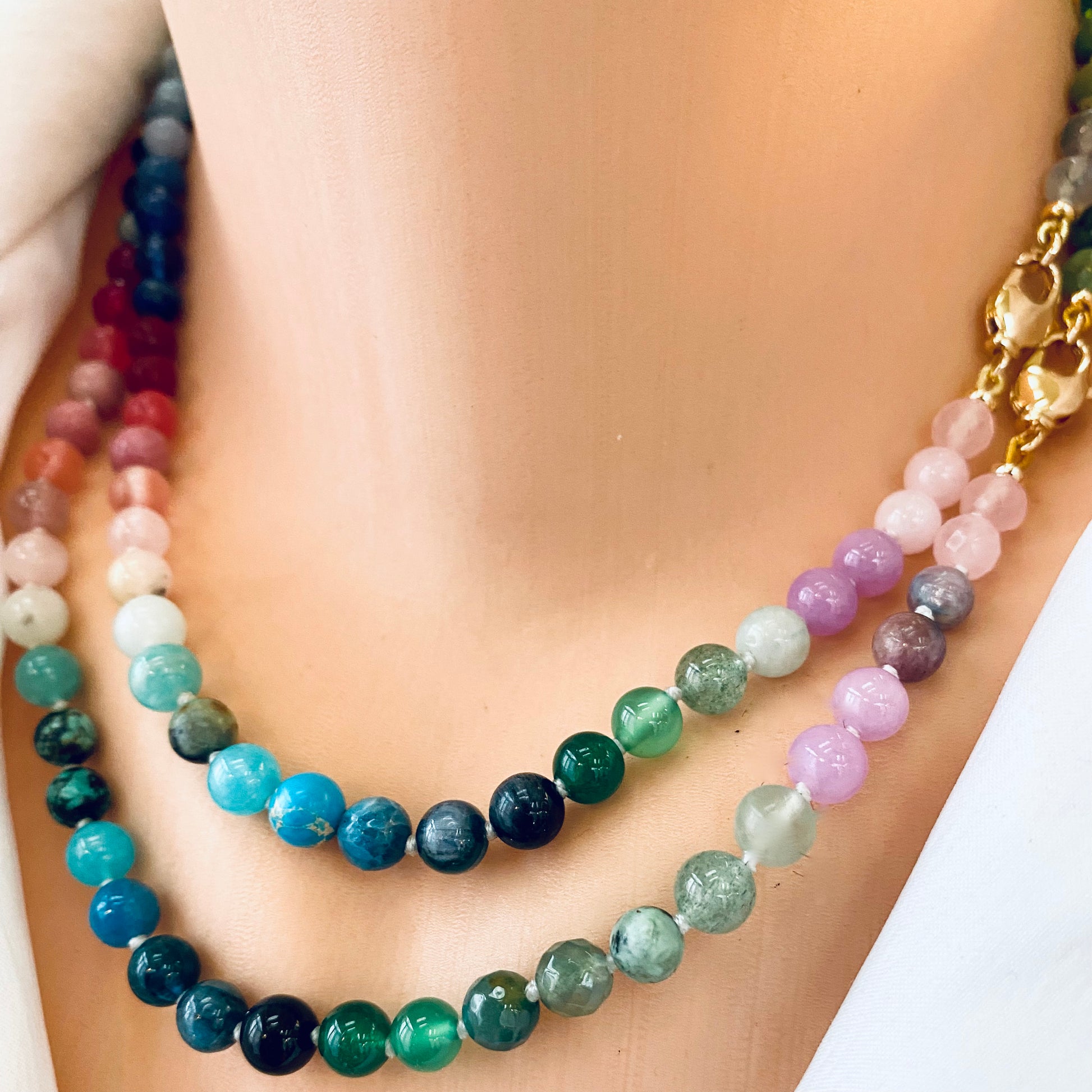 Close-up of a rainbow candy necklace in mini gemstone beads displaying vibrant colors and natural stones.