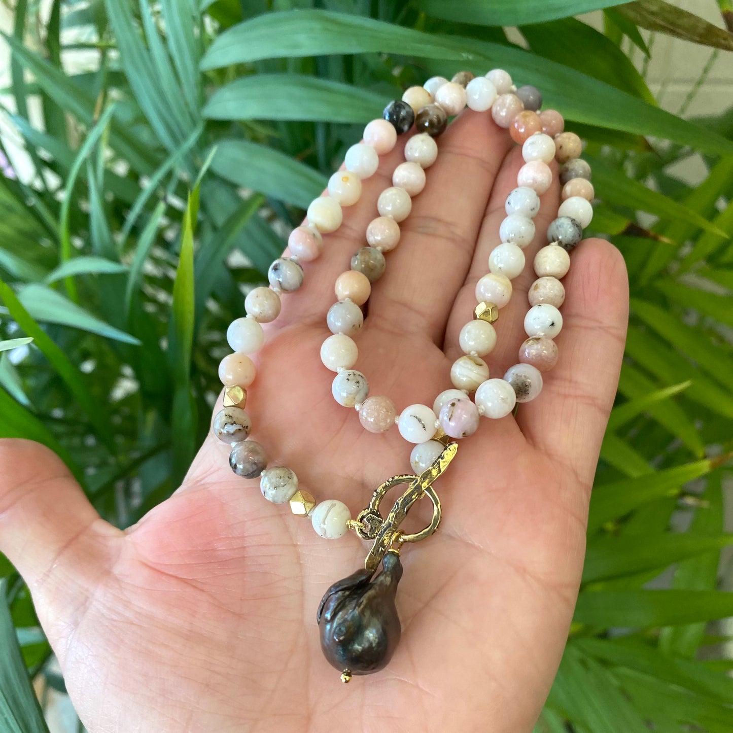 Pink opal baroque pearl necklace featuring hand knotted pink opal beads and gold bronze toggle