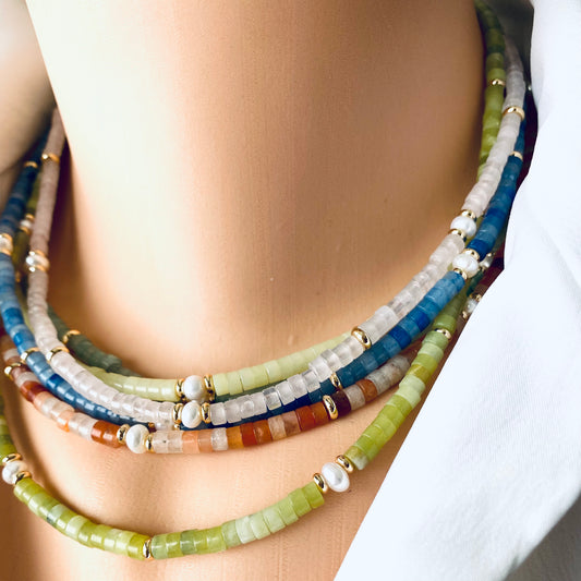Multi gemstone choker necklaces layered on model with pearls and colorful gemstone beads