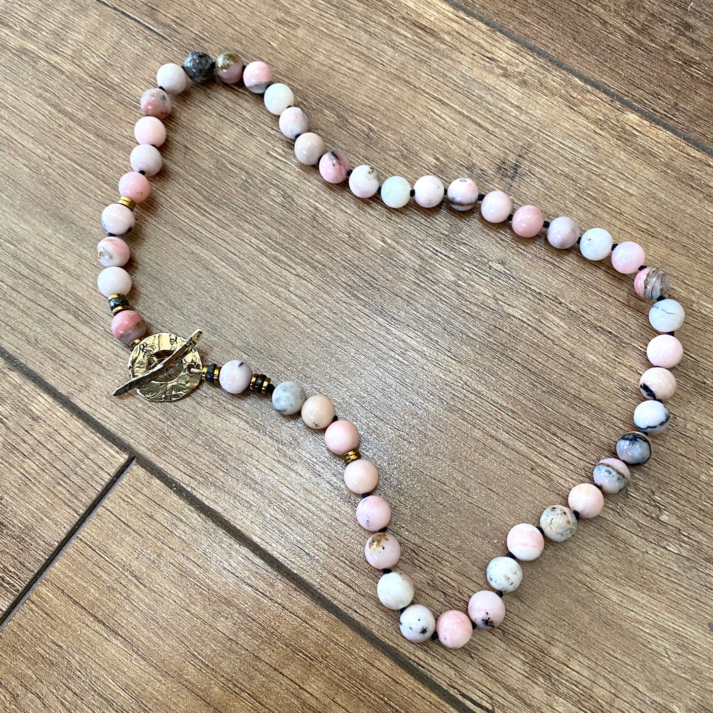 Pink opal hematite necklace with hand knotted pink opal beads and gold bronze toggle clasp
