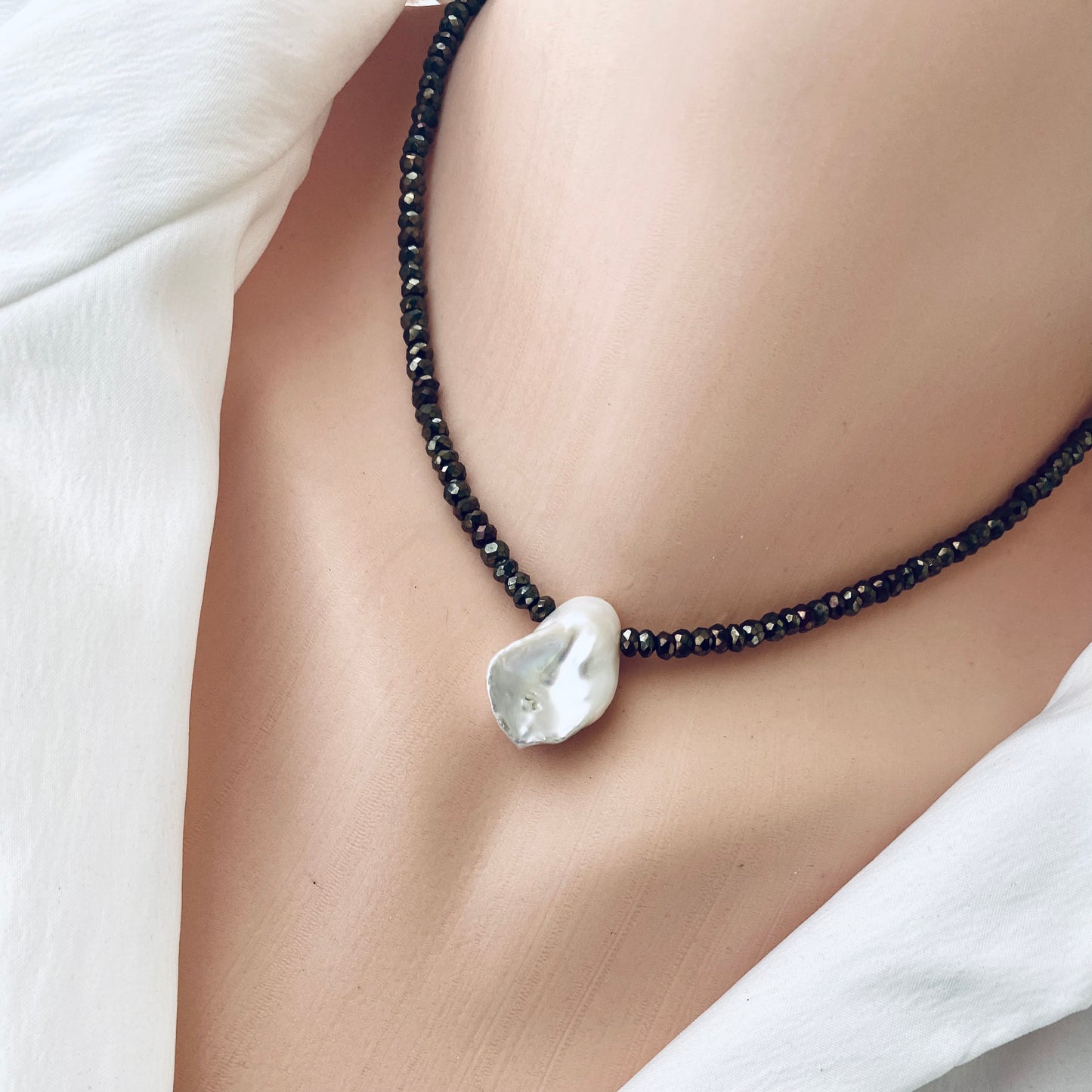 Pyrite pearl choker necklace with white keshi pearl highlighting elegant design and organic beauty.