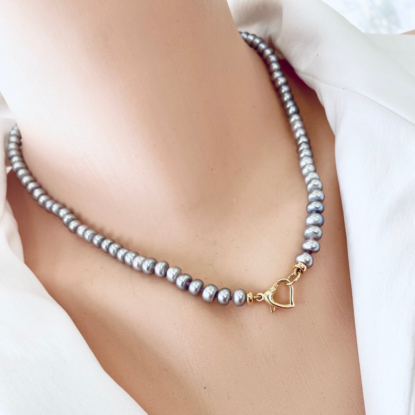 Grey pearl necklace featuring elegant freshwater rondelle pearls and a heart-shaped clasp.