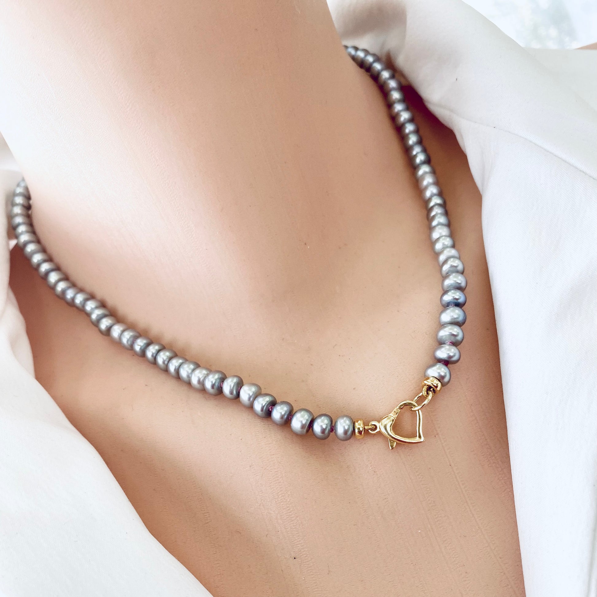 Grey pearl necklace featuring elegant freshwater rondelle pearls and a heart-shaped clasp.