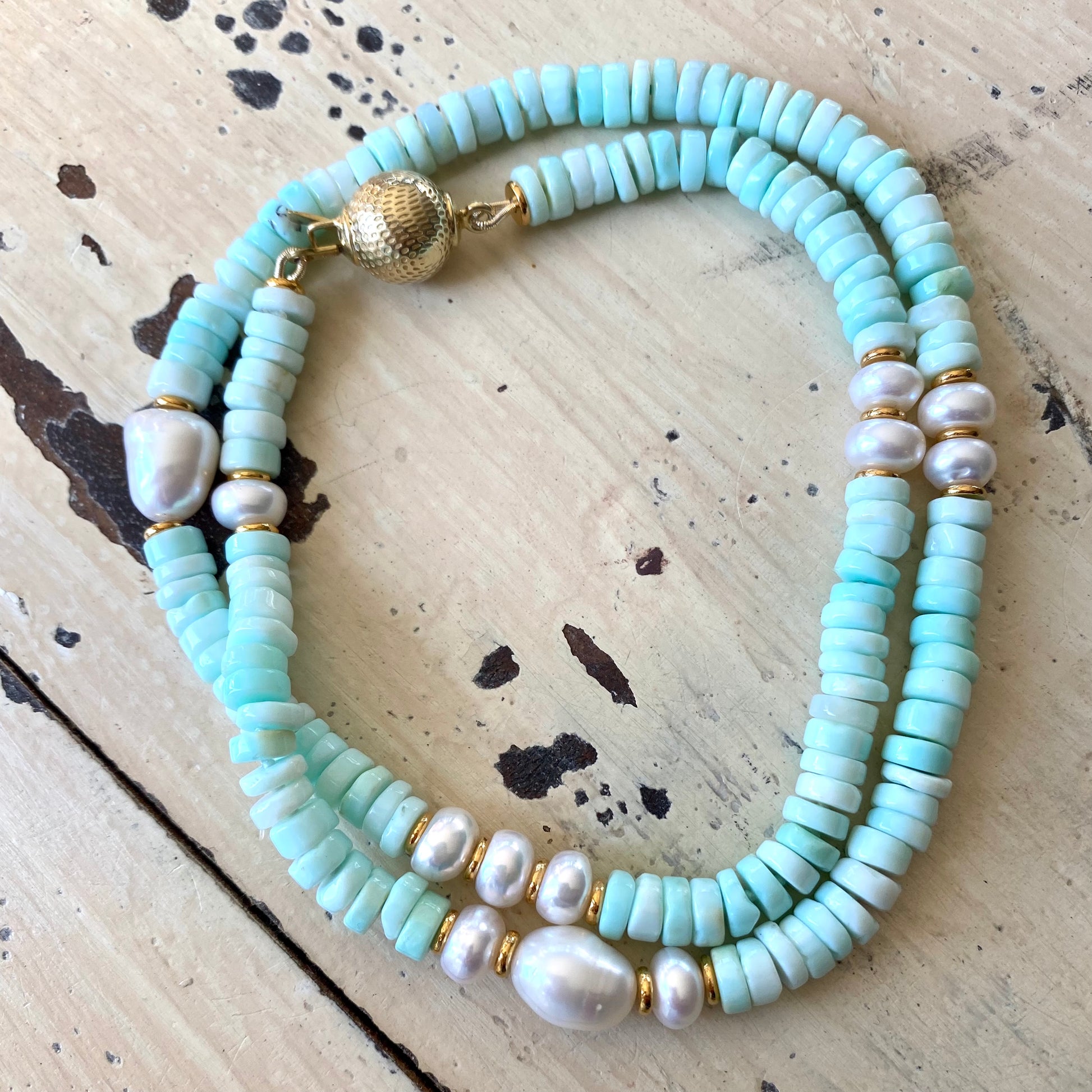 Sky blue opal pearl necklace laid flat showing opal tire beads and pearl accents, handcrafted in Canada