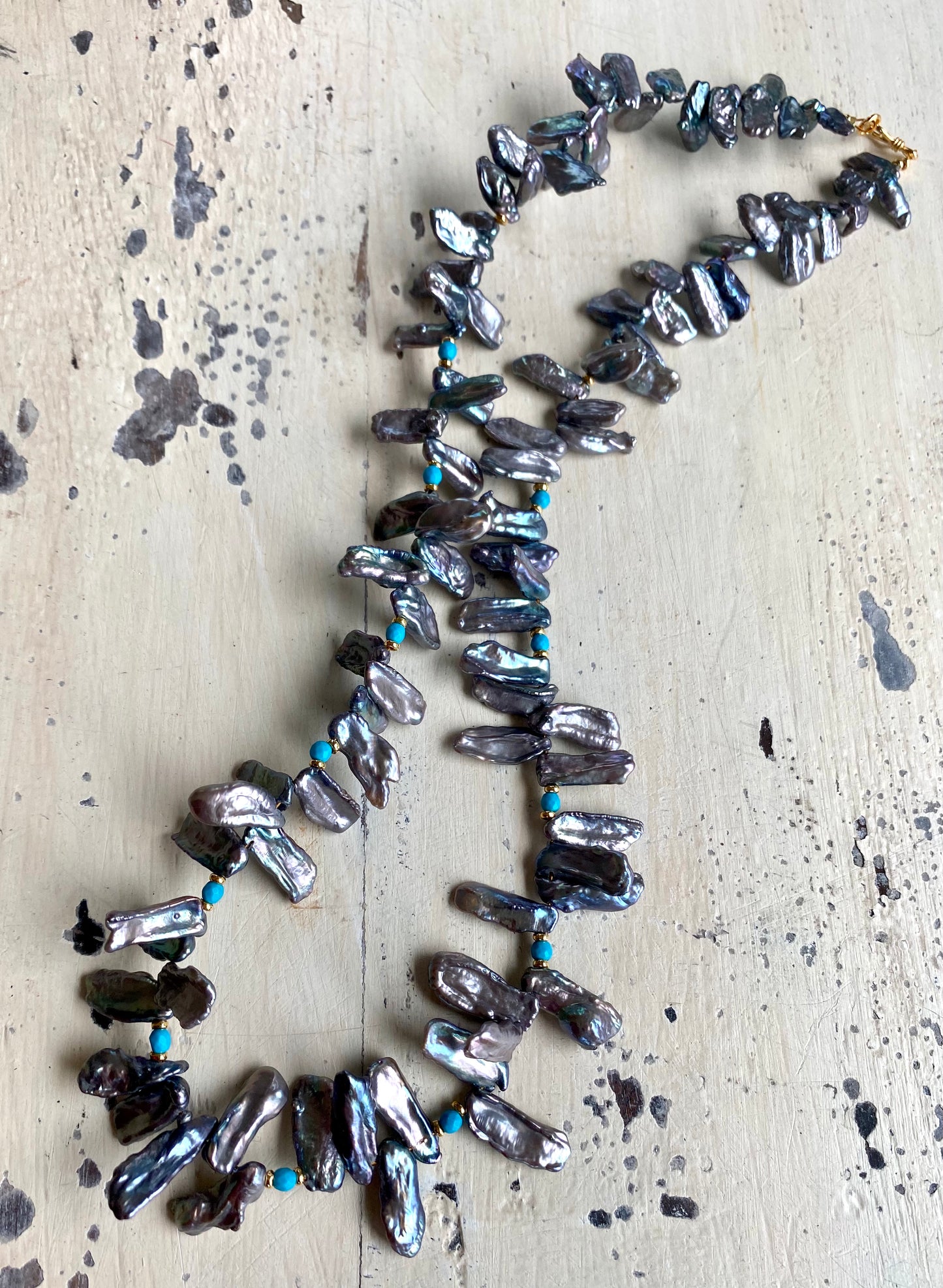 Biwa pearl turquoise necklace flat lay, keshi stick pearls with faceted turquoise and vermeil accents