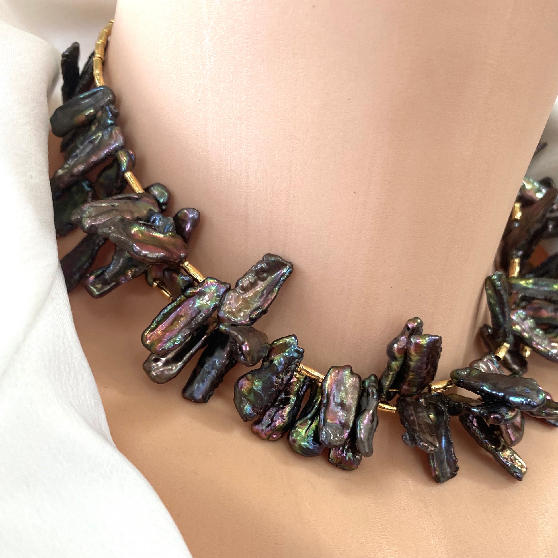 Black pearl choker necklace neckline close-up, peacock Biwa stick pearls statement choker