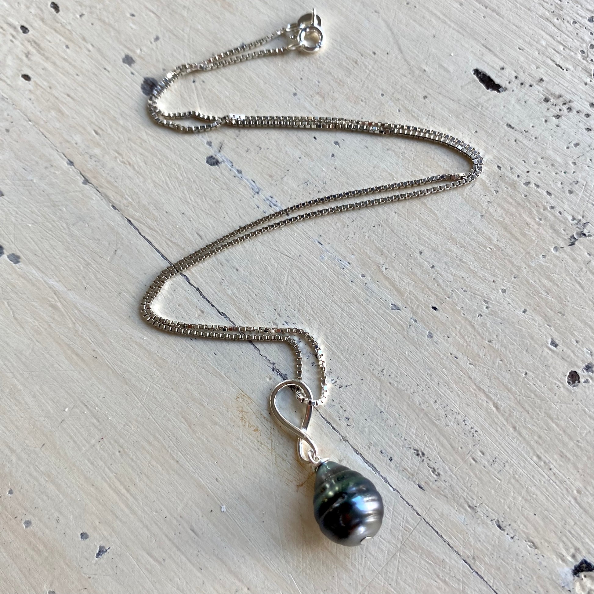 Tahitian teardrop pearl pendant box chain flat lay, sterling silver chain with teardrop pearl pendant