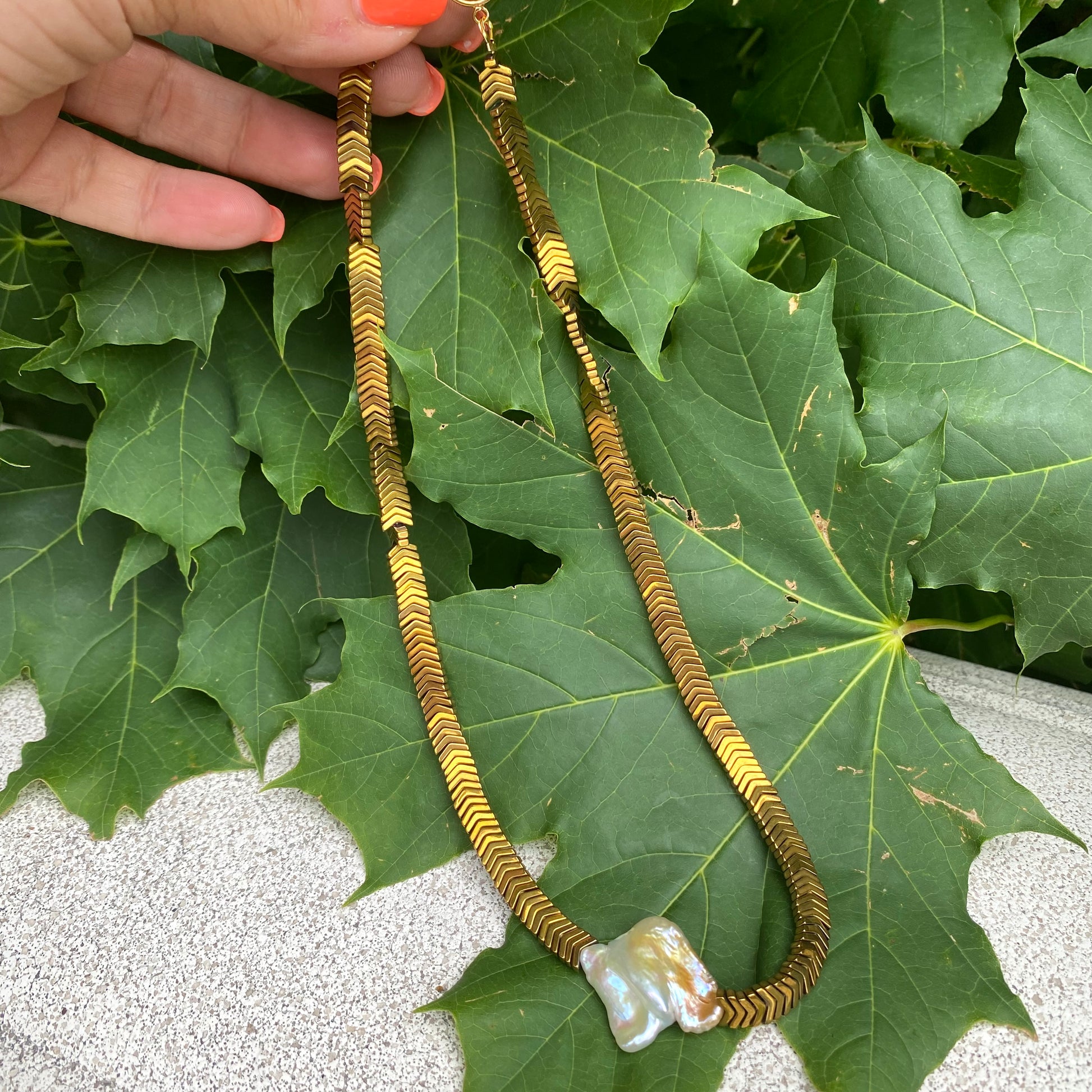 Gold hematite keshi pearl necklace photographed outdoors showing full length and toggle closure