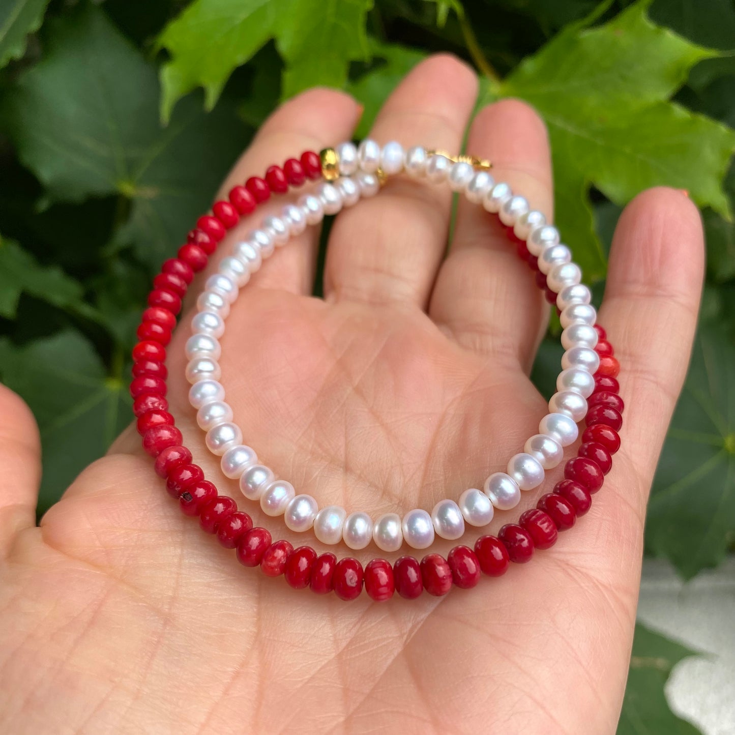 Half Coral Half Pearl Choker Necklace in hand close-up, gold vermeil donut spacer bead between coral and pearls
