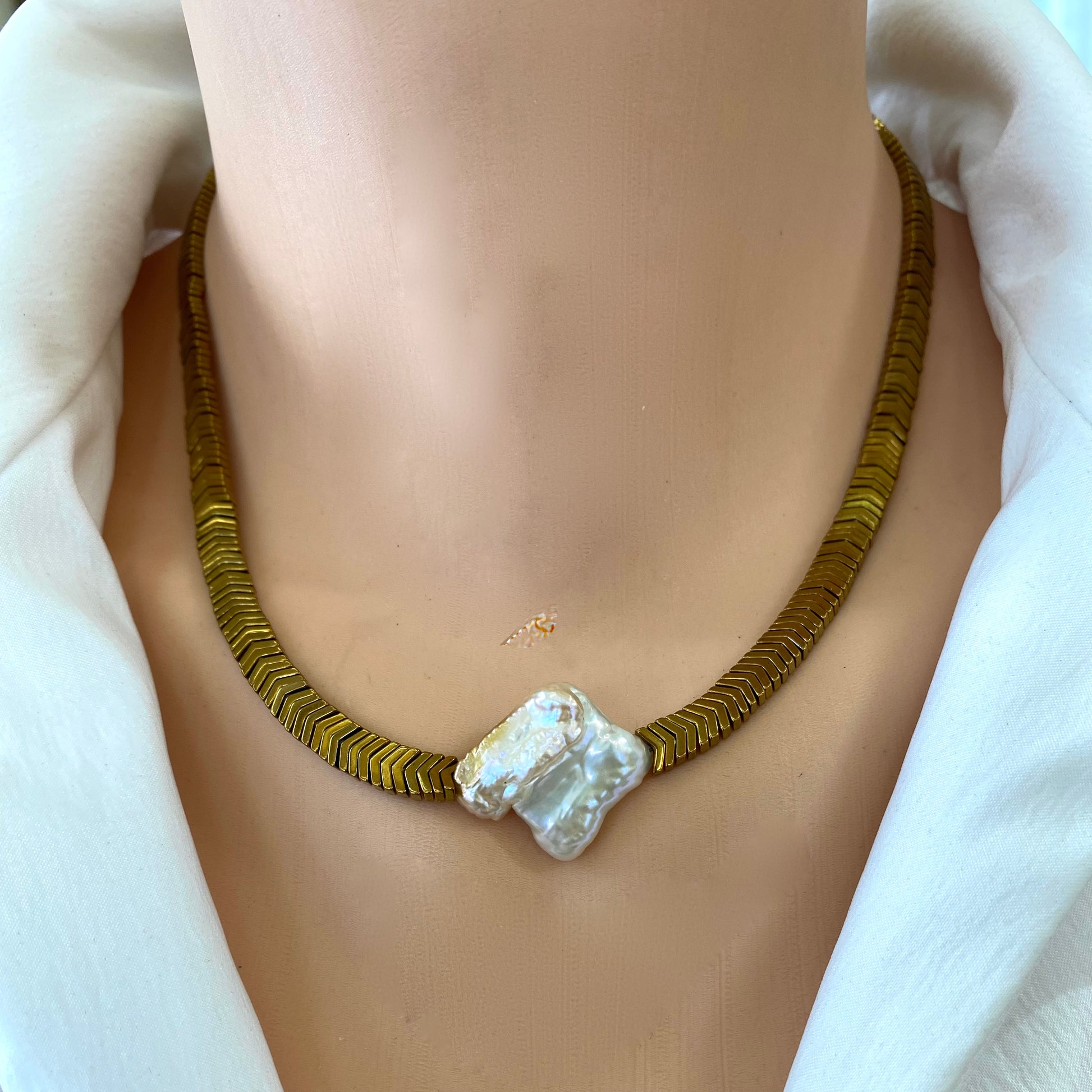 Gold hematite keshi pearl necklace worn alone as a statement piece at the neckline