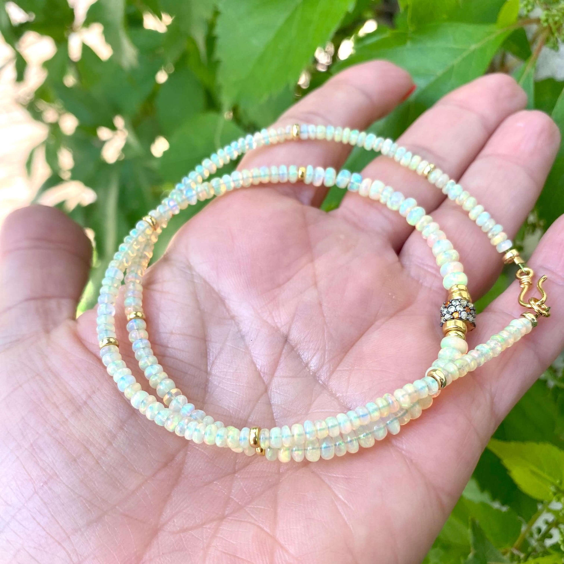 Ethiopian opal necklace in hand, Ethiopian opal rondelles and multi sapphire pavé detail close-up