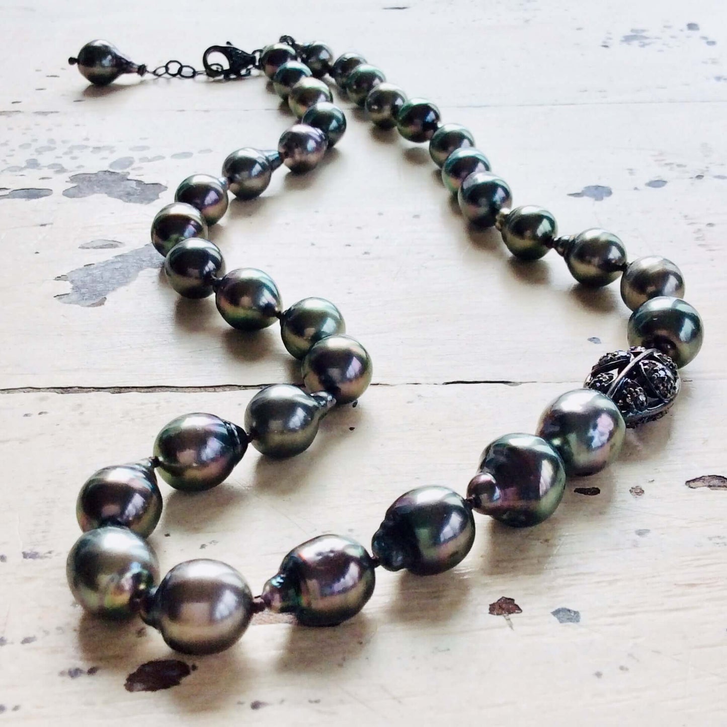 Tahitian baroque pearl necklace with champagne diamonds showcasing deep grey pearls and elegant design.