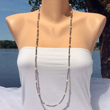 Charger l&#39;image dans la galerie, Labradorite pearl necklace 40 inches displayed on a mannequin by the water, showcasing its elegant design and natural beauty.
